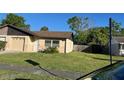 Well-kept house with green grass, a sturdy roof and green trees at 908 Boulder Dr, South Daytona, FL 32119