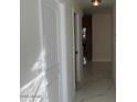 Hallway with new white marble floors, white walls and bright lighting at 908 Boulder Dr, South Daytona, FL 32119