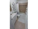 Well-lit bathroom featuring a shower-tub combo, white vanity, and stylish decorative accents at 921 Valleydale Ave, Deland, FL 32720