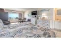 Interior view of condo featuring bed, dressers, dining area and a view of the beach at 935 S Atlantic Ave # 363, Daytona Beach, FL 32118