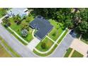 Overhead view of a gray home showcasing its manicured yard, driveway, and proximity to a quiet street at 941 Pizarro Dr, Daytona Beach, FL 32119