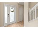 Inviting entryway with tile flooring and a decorative glass front door and sidelight at 109 Fern Springs St, Debary, FL 32713
