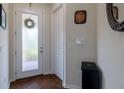 Bright entryway featuring a glass panel front door and wood-look floors at 1118 Avery Meadows Way, Deland, FL 32724