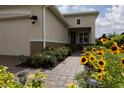 Well-maintained front yard with walkway and colorful flowers leading to the charming single story home at 1118 Avery Meadows Way, Deland, FL 32724