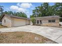 Charming single-story home featuring a stone facade and a two-car garage at 1209 James Ter, Daytona Beach, FL 32117