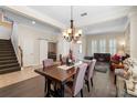 Elegant dining area showcasing a wooden table, chandelier, and a cozy fireplace at 123 Ivydale Manor Dr, Deland, FL 32724
