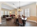 Charming dining room with wood floors and a fireplace, seamlessly connected to the living area at 123 Ivydale Manor Dr, Deland, FL 32724