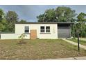 Charming single-story home featuring a modern color scheme and well-maintained landscaping at 1408 W Wellington Dr, Deltona, FL 32725