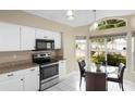 Bright kitchen features modern appliances and a cozy breakfast nook at 14634 Brightwell Ct, Orlando, FL 32824
