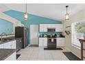 Bright kitchen featuring granite counters, white cabinets, and stainless steel appliances at 149 Angeles Rd, Debary, FL 32713
