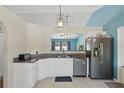 Bright kitchen featuring granite counters, white cabinets, and stainless steel appliances at 149 Angeles Rd, Debary, FL 32713