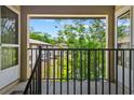 Balcony view featuring verdant trees and the exterior of a nearby building at 1601 Big Tree Rd # 1302, South Daytona, FL 32119