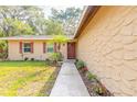 Inviting front entrance with meticulously maintained landscaping leading to a cozy, single-story home at 1617 Tuscaloosa Ave, Daytona Beach, FL 32117