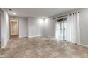 Spacious living room featuring tile floors, neutral walls, and a sliding glass door with lots of natural light at 1617 Tuscaloosa Ave, Daytona Beach, FL 32117