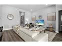 Inviting living room with a comfortable sectional sofa, stylish decor, and open access to other living areas at 165 Azure Mist Way, Daytona Beach, FL 32124