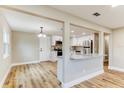 Open-concept living space featuring new flooring, and a modern kitchen with stainless steel appliances at 165 S Massachusetts Ave, Deland, FL 32724