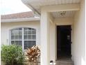 Inviting home entrance featuring a covered doorway and large window at 1714 Urbana Ave, Deltona, FL 32725