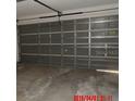 Spacious two-car garage featuring a garage door with metal supports at 1714 Urbana Ave, Deltona, FL 32725