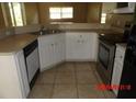 Functional kitchen with ample counter space, white cabinets, and stainless steel appliances at 1714 Urbana Ave, Deltona, FL 32725