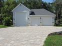 Spacious three car garage and stylish driveway with an ample room for multiple cars at 1870 Pepper Tree Ln, Deland, FL 32720