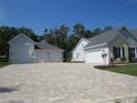 Oversized 3-car garage and driveway offering ample parking space, with attractive paver detail at 1870 Pepper Tree Ln, Deland, FL 32720