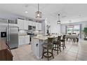 Modern kitchen features stainless steel appliances, granite countertops, and island seating, perfect for entertaining at 2000 White Pelican Ter, Sanford, FL 32771
