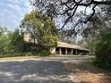 Rustic home with a long driveway surrounded by mature trees and natural landscaping at 2068 Pennsylvania Dr, Deland, FL 32724