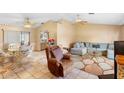 Cozy living room featuring tile floors, ceiling fans, and lots of natural light at 2287 Belen Dr, Deltona, FL 32738