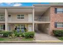 Two-story condo with front patios, lush landscaping, and designated parking below at 2500 Lee Rd # 134, Winter Park, FL 32789