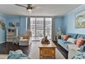Cozy living room with neutral tones, balcony access, and comfortable seating at 2800 N Atlantic Ave # 206, Daytona Beach, FL 32118