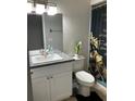 Cozy bathroom with a granite-topped vanity, sleek sink, and modern fixtures at 2841 Beal St, Deltona, FL 32738