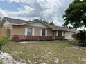 Charming single-story home featuring brick accents, white shutters, and a well-manicured lawn at 2841 Beal St, Deltona, FL 32738