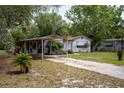 Welcoming single-story house with a covered carport and a well-maintained lawn at 29505 North, Paisley, FL 32767