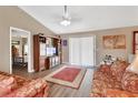 Cozy living room featuring a large TV cabinet, ceiling fan, and lots of natural light at 3001 Inca Ct, Deltona, FL 32738