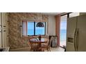 Eat-in kitchen with ample cabinet space provides ocean views and access to the balcony at 3003 S Atlantic Ave # 21A2, Daytona Beach Shores, FL 32118