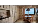 Eat-in kitchen features generous cabinet space, a table for four, and views of the ocean at 3003 S Atlantic Ave # 21A2, Daytona Beach Shores, FL 32118