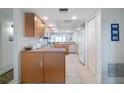 Well-lit kitchen featuring white appliances and plenty of storage with wood cabinets at 3145 S Atlantic Ave # 503, Daytona Beach Shores, FL 32118