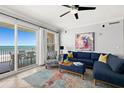 Inviting living room with comfortable seating and scenic ocean views from the sliding glass doors at 3245 S Atlantic Ave # 304, Daytona Beach Shores, FL 32118