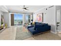 Bright living room features a large sectional sofa and expansive ocean views through sliding glass doors at 3245 S Atlantic Ave # 304, Daytona Beach Shores, FL 32118