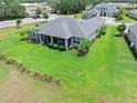 Landscaped backyard featuring a well-manicured lawn, mature shrubs, and beautiful trees, creating an inviting outdoor space at 3322 Modena Way, New Smyrna Beach, FL 32168