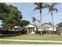 Inviting home with palm trees, manicured lawn, and a welcoming front entrance at 340 Hampton Hills Ct, Debary, FL 32713