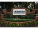 Entrance to DeBary Golf and Country Club featuring the club's signage and lush landscaping at 340 Hampton Hills Ct, Debary, FL 32713