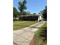 A modest brick ranch-style home with a long driveway at 404 Brentwood Ave, Deland, FL 32724