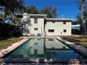Outdoor pool with reflection of home on a sunny day at 404 Brentwood Ave, Deland, FL 32724
