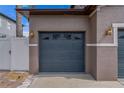 A blue two car garage door with decorative windows and carriage house style lighting at 4604 Barbados Loop, Clermont, FL 34711