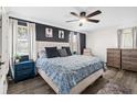 Spacious main bedroom with a ceiling fan, bedside table, and dual dressers at 51 Silk Moss Ct, South Daytona, FL 32119