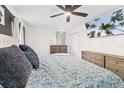 Bright and airy main bedroom with a ceiling fan and wall-mounted TV at 51 Silk Moss Ct, South Daytona, FL 32119