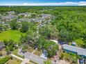 Aerial shot of a home with a well-maintained yard, complementing nearby apartments and lush landscapes at 511 Doctors Dr, Oviedo, FL 32765