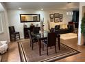 Inviting dining area with modern table, decorative rug, and seamlessly connected to the living space at 516 Hickorywood Ave, Altamonte Springs, FL 32714