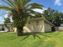 Exterior side view with mature palm trees and stone accents at 516 Hickorywood Ave, Altamonte Springs, FL 32714